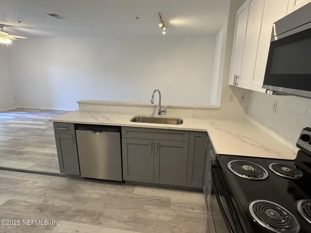 a kitchen with a stove and a sink