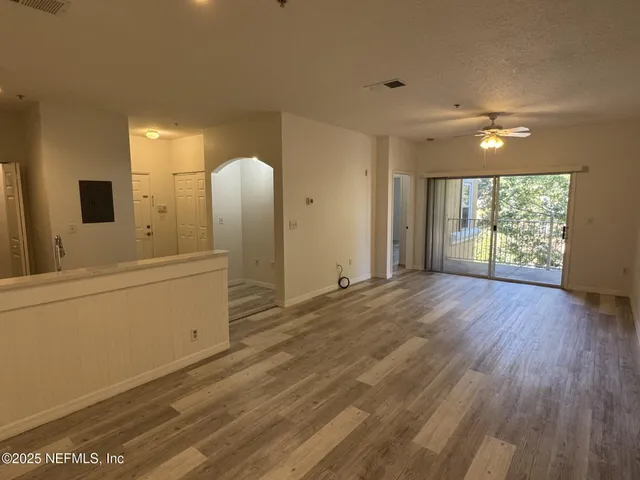 a view of a livingroom with a furniture wooden floor and window