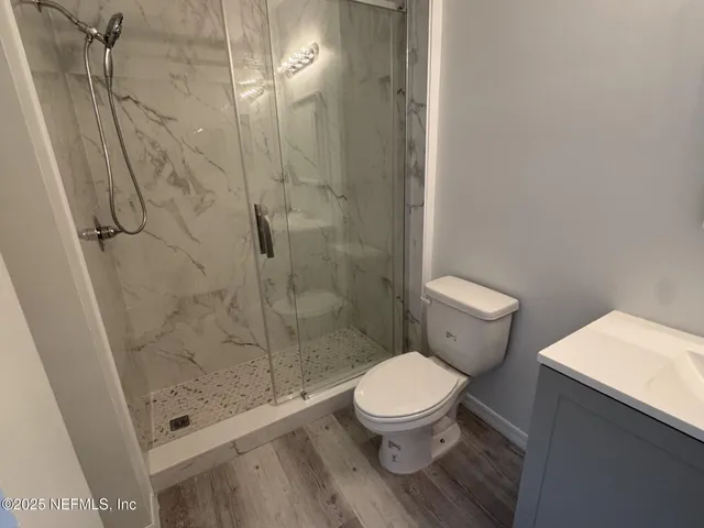 a bathroom with a toilet and a shower