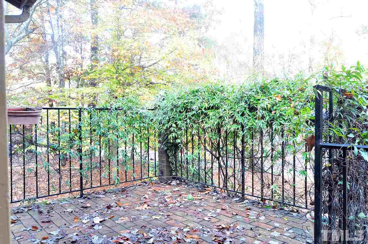 6 Pinnacle Road Durham, NC 27705 - Photo 2 of 24 a view of a backyard with large trees and wooden fence