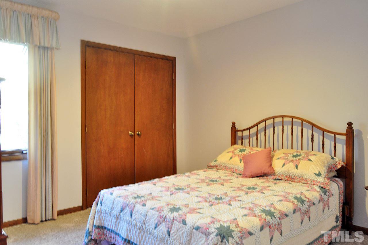 6 Pinnacle Road Durham, NC 27705 - Photo 17 of 24 a bedroom with a bed and a window