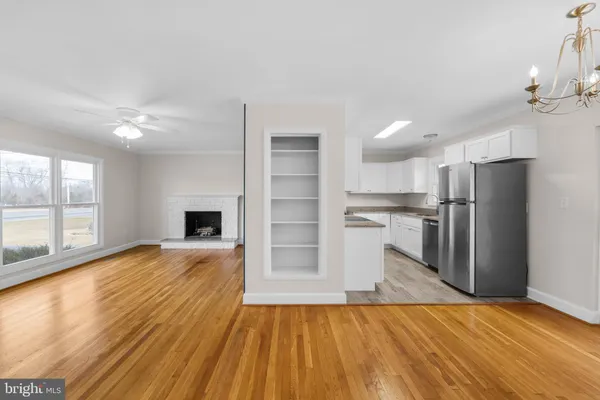 a view of kitchen with refrigerator and wooden floor