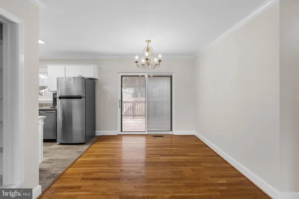 a view of a kitchen with a sink and refrigerator