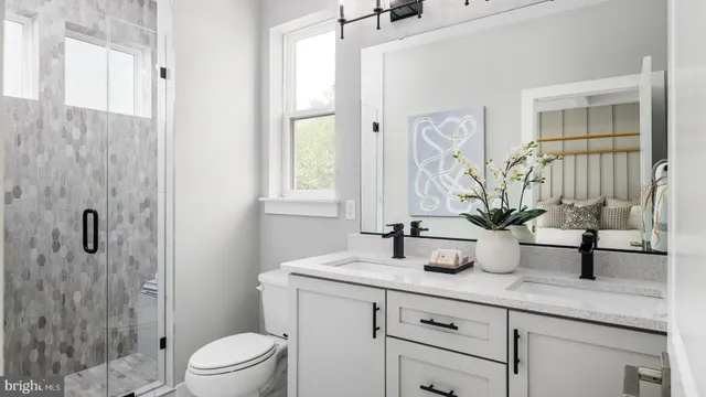 a bathroom with a granite countertop sink a toilet and shower