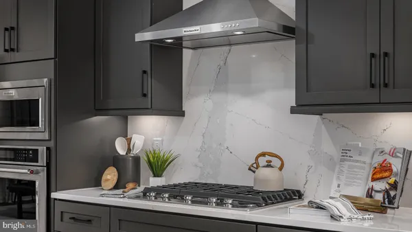 a stove top oven sitting inside of a kitchen