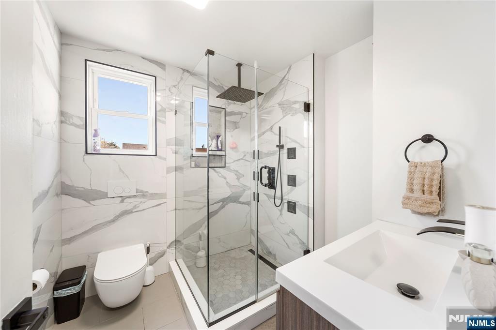 124 Hazley Avenue Rochelle Park, NJ 07662 - Photo 15 of 33 a bathroom with a sink toilet and shower