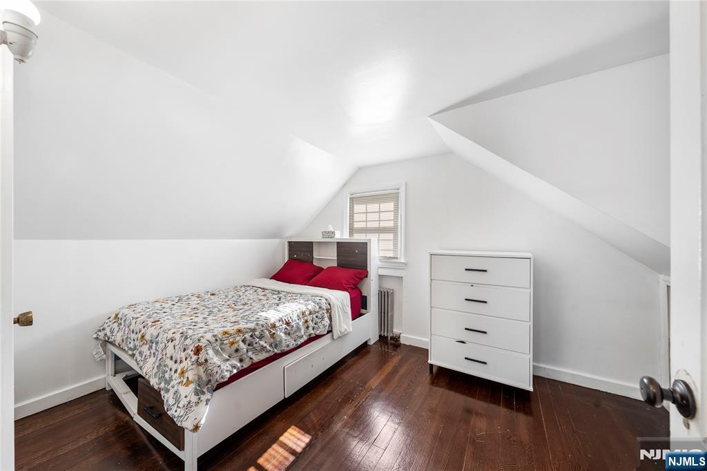 124 Hazley Avenue Rochelle Park, NJ 07662 - Photo 16 of 33 a bedroom with a bed and wooden floor