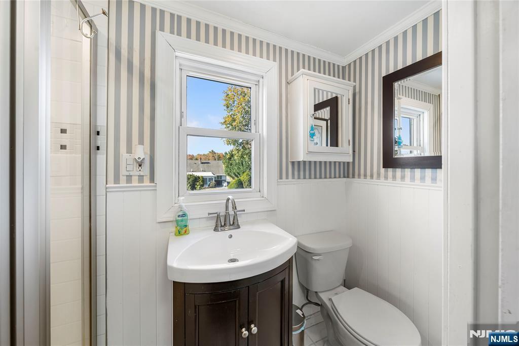 124 Hazley Avenue Rochelle Park, NJ 07662 - Photo 20 of 33 a bathroom with a toilet a sink and a mirror