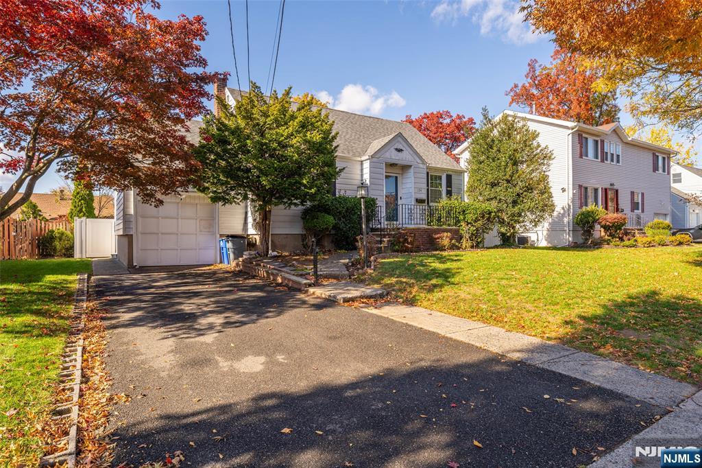 124 Hazley Avenue Rochelle Park, NJ 07662 - Photo 3 of 33 a front view of a house with yard and garage