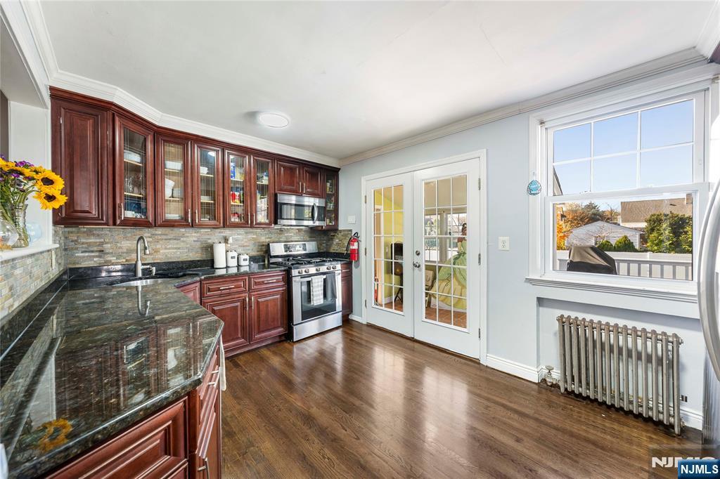 124 Hazley Avenue Rochelle Park, NJ 07662 - Photo 9 of 33 a kitchen with stainless steel appliances granite countertop a stove and a wooden floors
