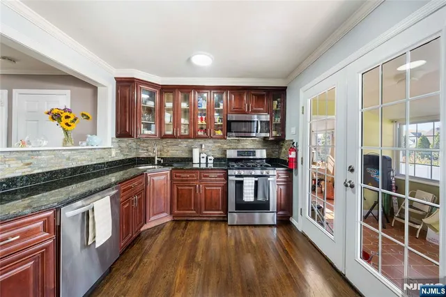 a kitchen with stainless steel appliances granite countertop a stove and a sink