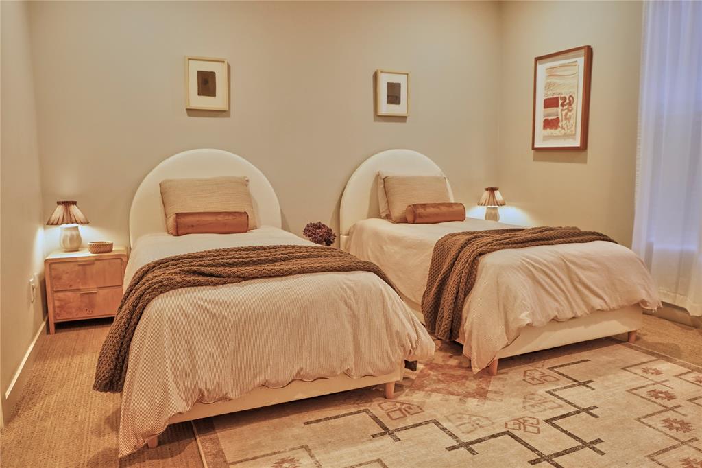 4026 Travis Street, Unit E Dallas, TX 75204 - Photo 15 of 19 a bedroom with two beds and a couch