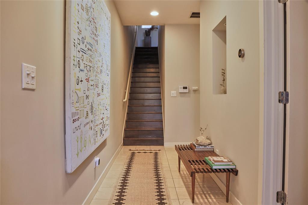 4026 Travis Street, Unit E Dallas, TX 75204 - Photo 4 of 19 a view of a hallway with wooden floor and staircase