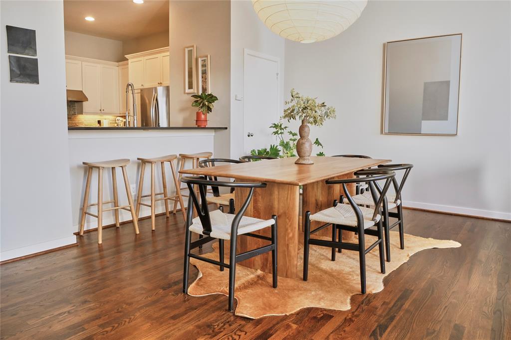 4026 Travis Street, Unit E Dallas, TX 75204 - Photo 7 of 19 a view of a dining room with furniture and wooden floor