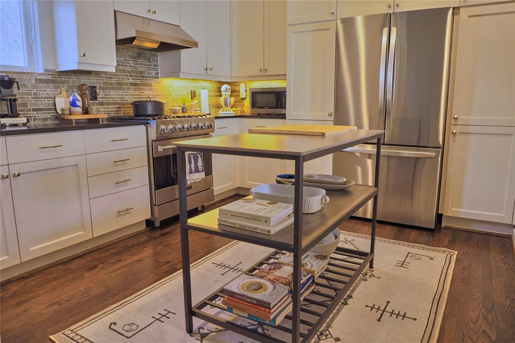 4026 Travis Street, Unit E Dallas, TX 75204 - Photo 8 of 19 a kitchen with stainless steel appliances granite countertop a stove a sink and a refrigerator