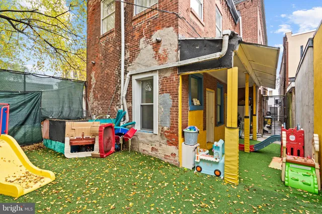 a backyard of a house with outdoor seating