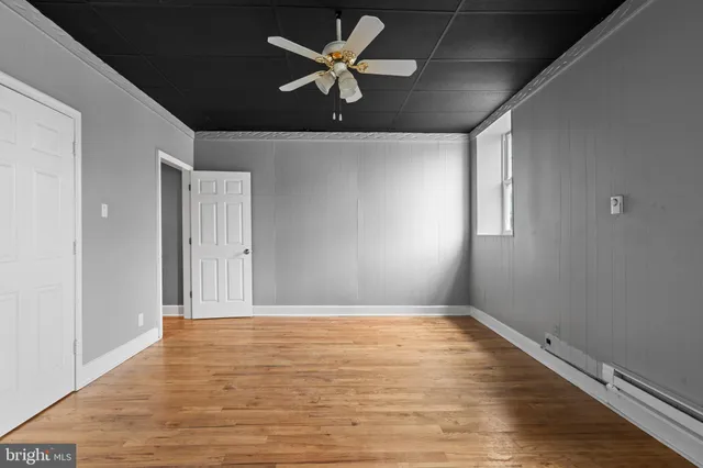 wooden floor in an empty room with a window