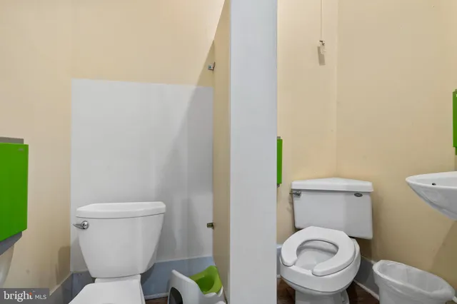 a white toilet sitting next to a shower