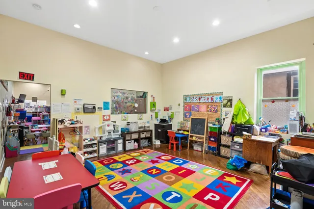 a bed room with furniture and a baby crib