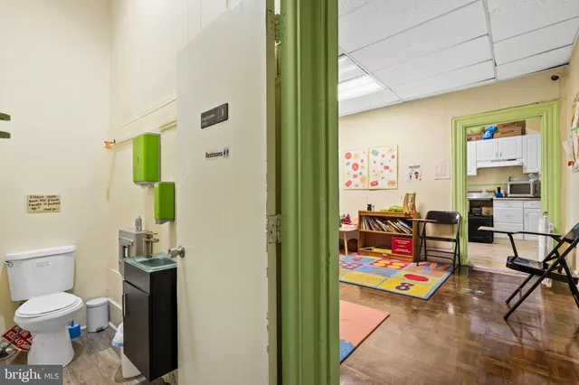 a living room with furniture a rug and a toilet