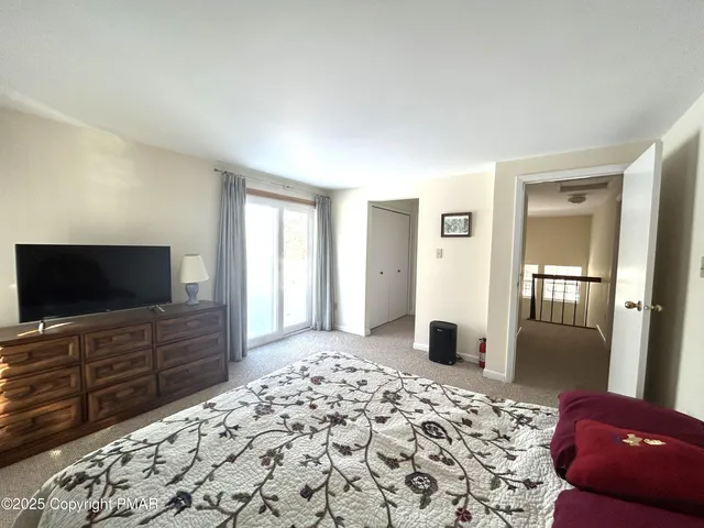 a bedroom with a bed and a flat screen television