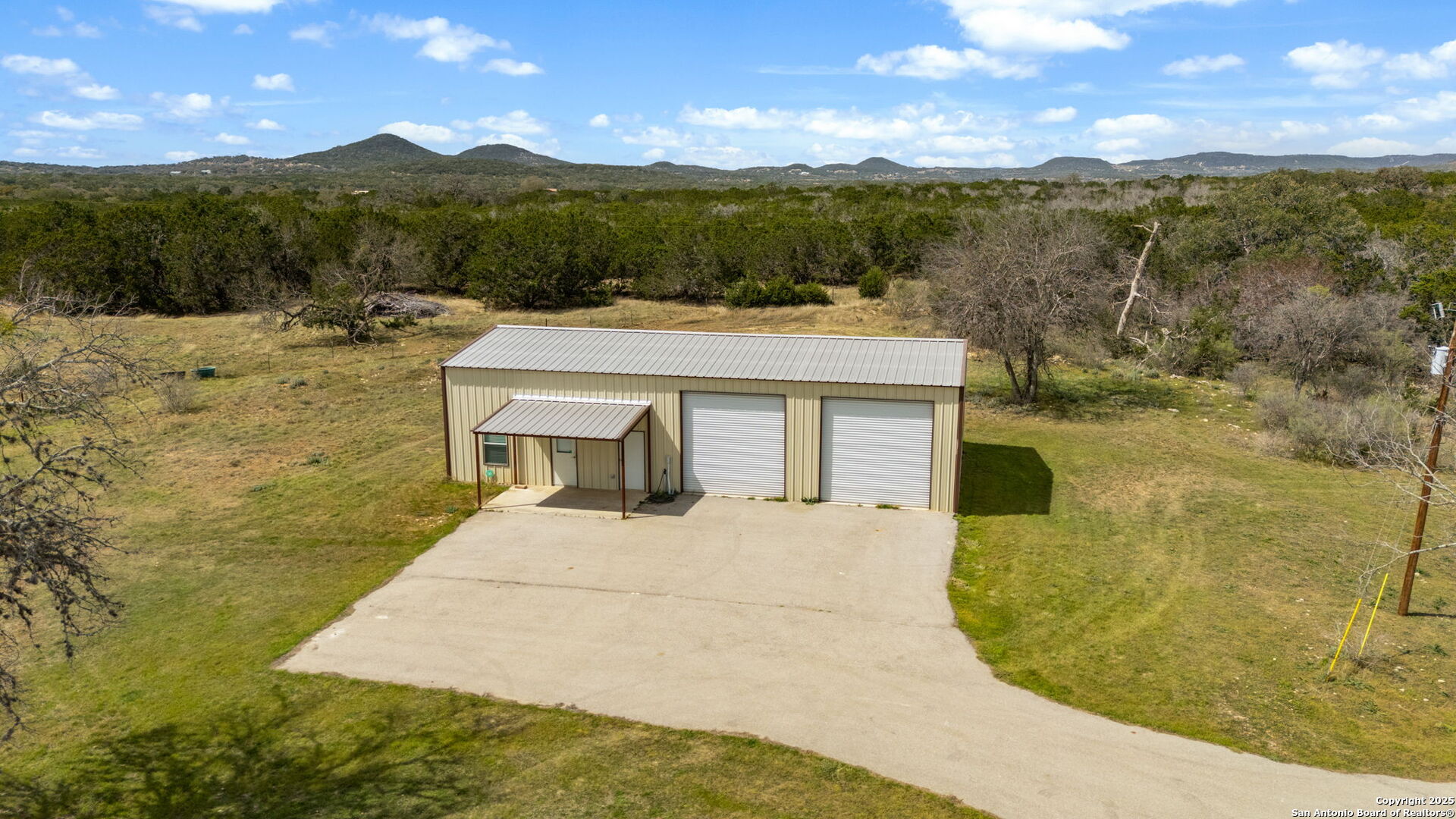 3584 Privilege Creek Road Pipe Creek, TX 78063 - Photo 36 of 66 a view of a terrace with a garden and mountain view