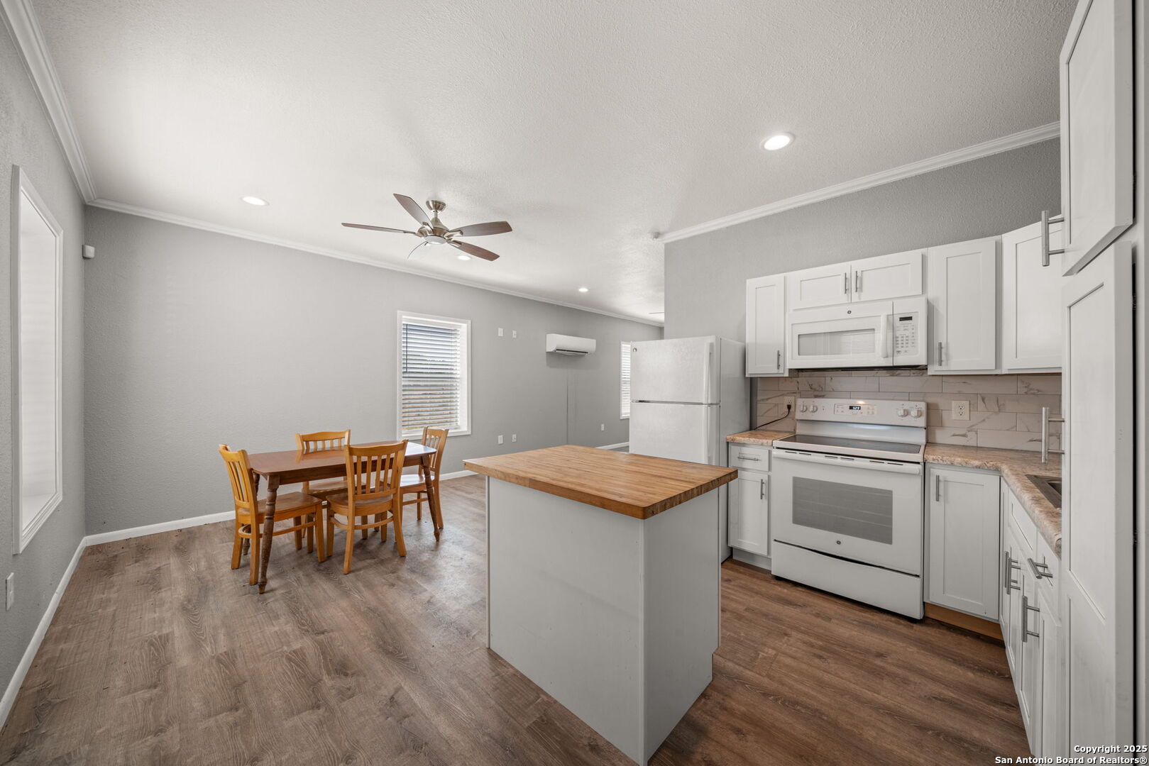 3584 Privilege Creek Road Pipe Creek, TX 78063 - Photo 57 of 66 a kitchen with stainless steel appliances granite countertop wooden floor and white cabinets