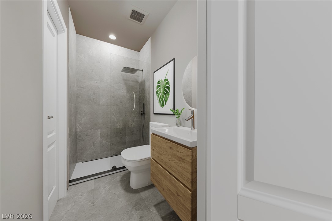 1140 Julie Road Henderson, NV 89002 - Photo 43 of 71 Virtually staged/remodeled. 1140 JULIE RD HENDERSON NV 89002. A well-appointed bathroom features a glass-enclosed shower and contemporary vanity with a round mirror.
