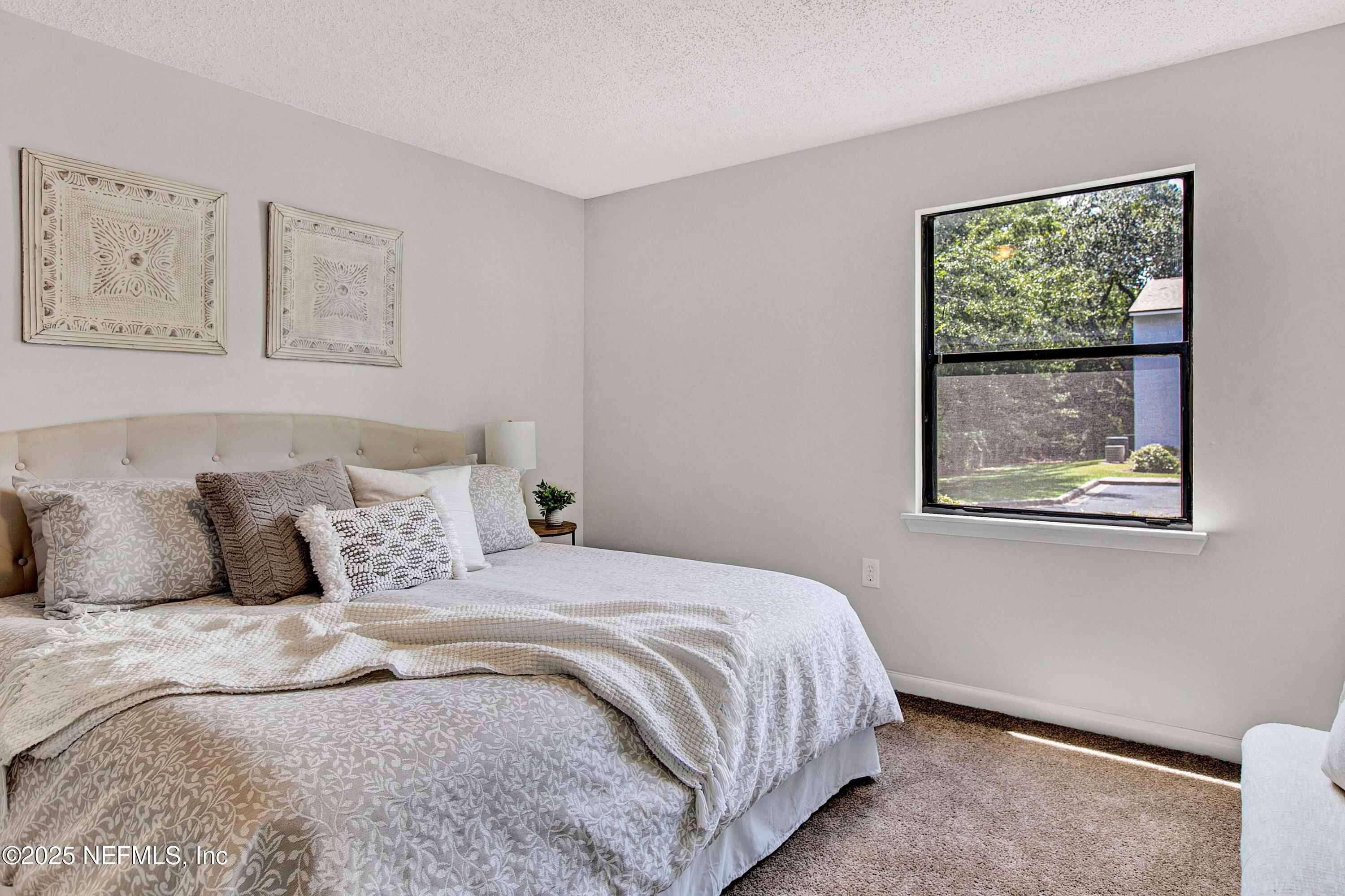 10825 Key Haven Boulevard, Unit 508 Jacksonville, FL 32218 - Photo 10 of 18 a bedroom with a bed and a window