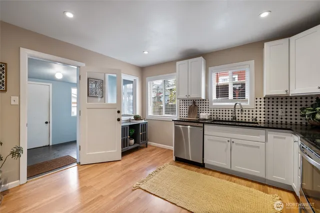 a kitchen with granite countertop a sink and cabinets