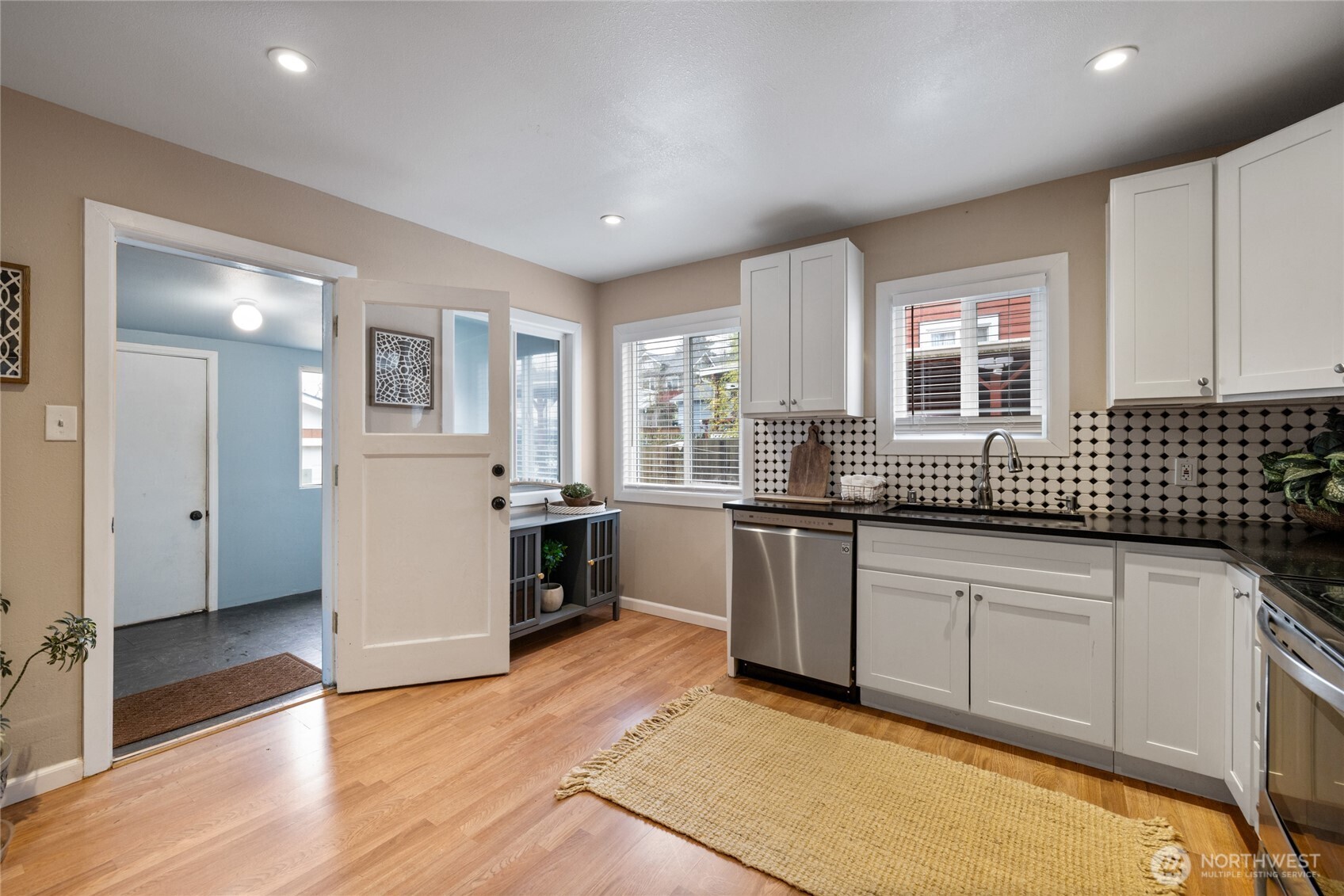 4011 East I Street Tacoma, WA 98404 - Photo 11 of 33 a kitchen with granite countertop a sink and cabinets