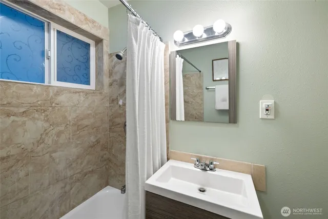 a bathroom with a sink mirror and vanity
