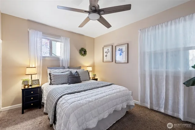 a bedroom with a large bed and a chandelier