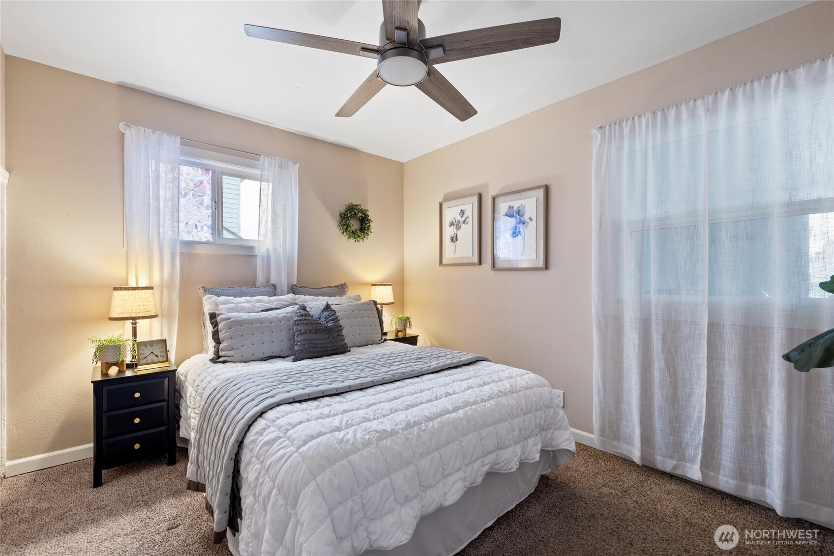 4011 East I Street Tacoma, WA 98404 - Photo 15 of 33 a bedroom with a large bed and a chandelier