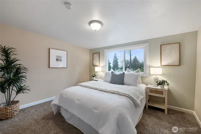 a bedroom with a large bed and a window