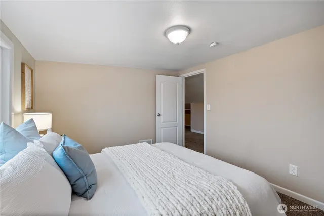 a bedroom with a bed and a lamp