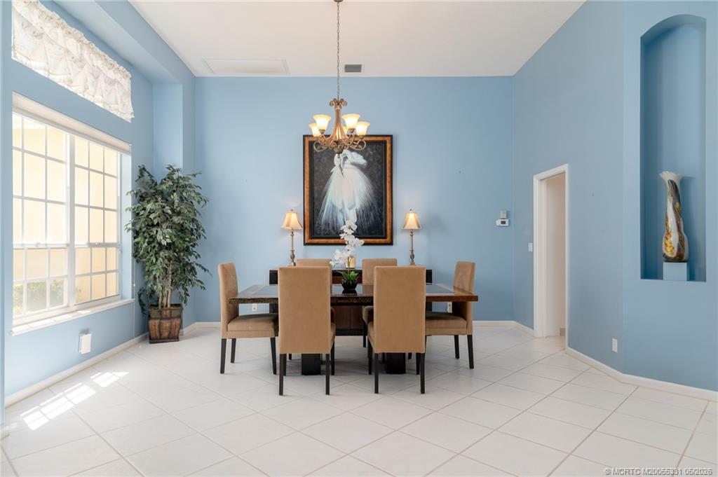 2216 Southeast Stonehaven Road Port St. Lucie, FL 34952 - Photo 9 of 67 a dining room with furniture and window