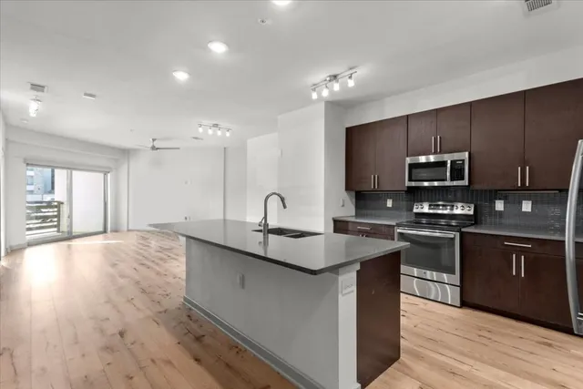 a kitchen with stainless steel appliances granite countertop a sink stove and oven