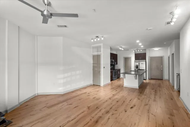 a view of a livingroom with furniture wooden floor and a window