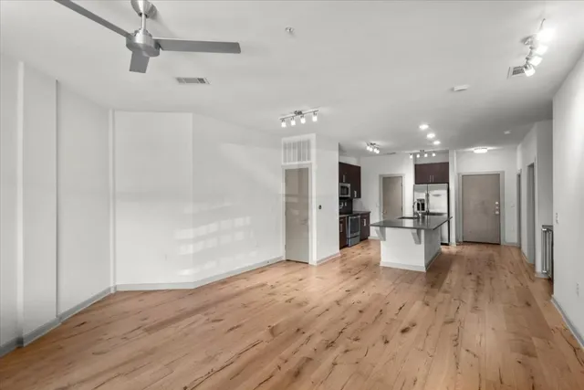 a view of a livingroom with furniture wooden floor and a window