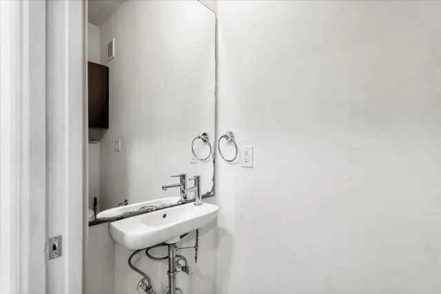 a bathroom with a sink and mirror