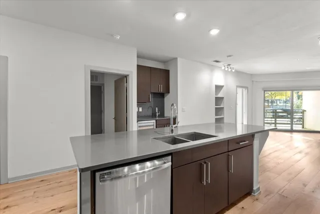 a kitchen with granite countertop a sink and cabinets
