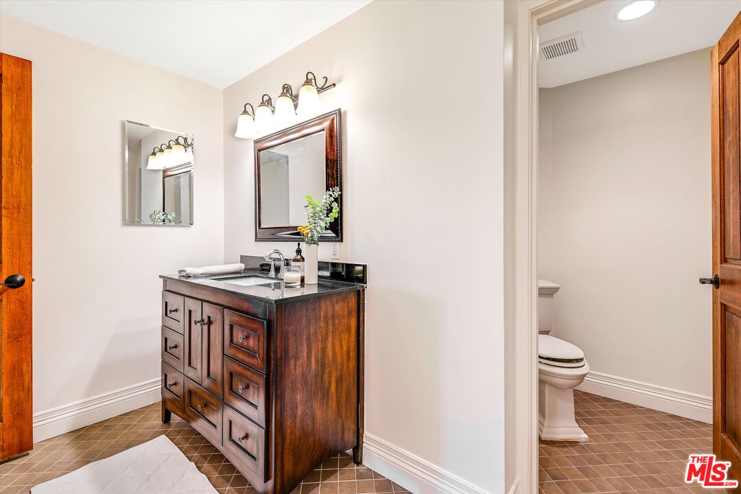 1405 Mayapan Road La Habra Heights, CA 90631 - Photo 20 of 54 a bathroom with a granite countertop sink and a toilet