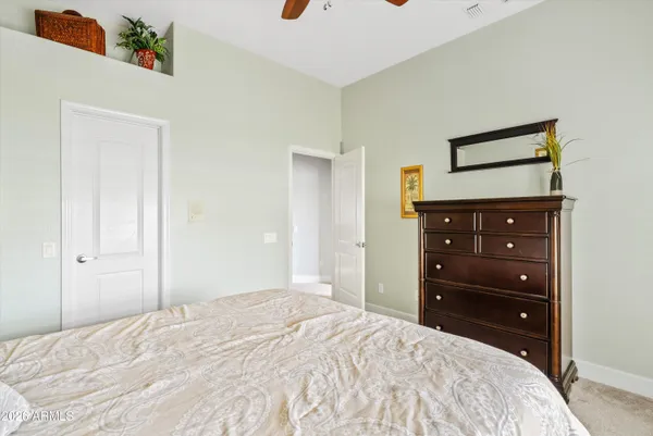 a living room with furniture and a ceiling fan