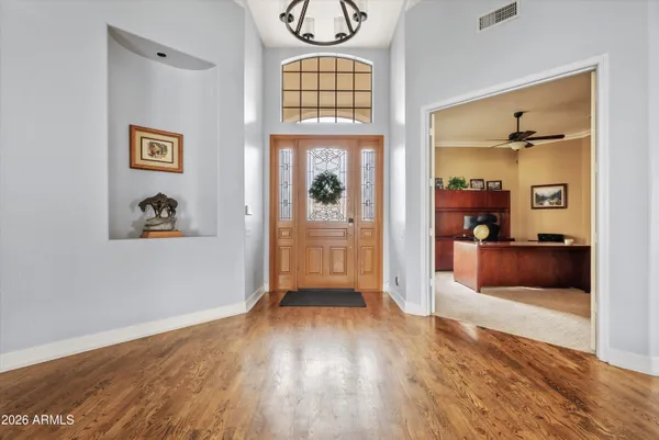 a kitchen with white cabinets and chairs