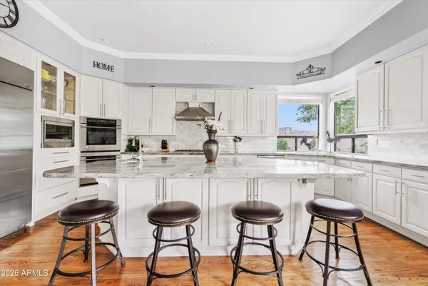 a kitchen with granite countertop a sink stove and cabinets