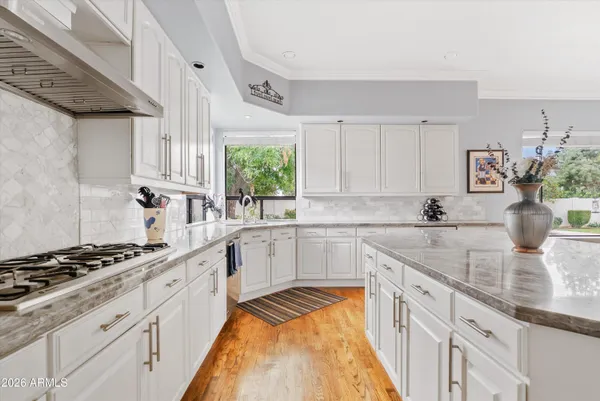 a kitchen with stainless steel appliances granite countertop a stove and cabinets