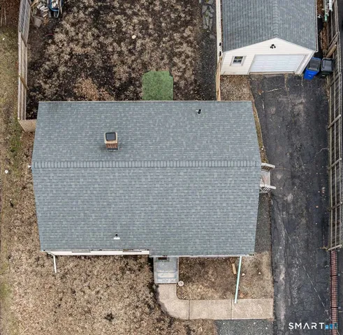 an aerial view of a house with a yard