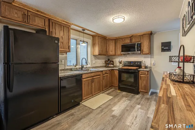 a kitchen with a refrigerator stove and sink