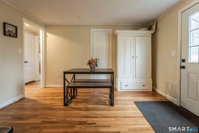 a view of a livingroom with wooden floor and a rug